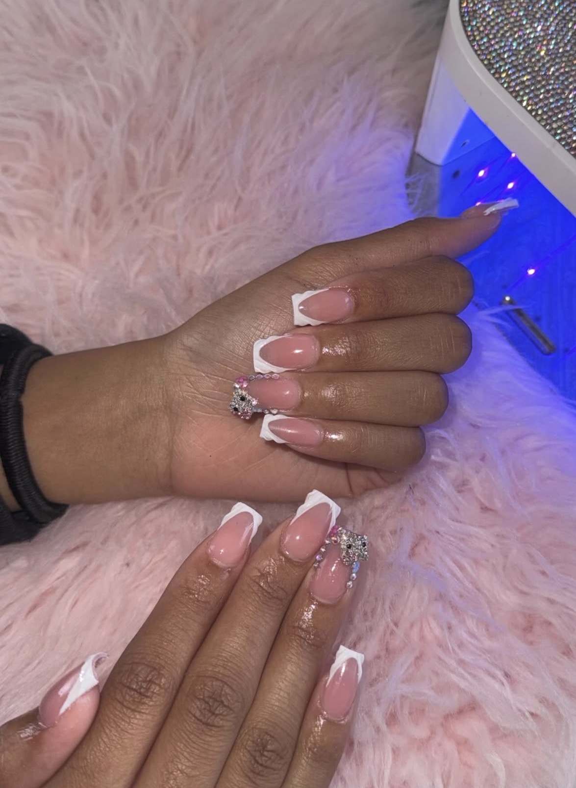 Brown cow print coffin nails with rhinestone accents